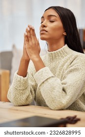 Religion, prayer and young woman in her living room with christian faith, gratitude and worship. Spiritual, hope and religious female person praying with her hands together to god in her modern home. - Shutterstock ID 2326828995