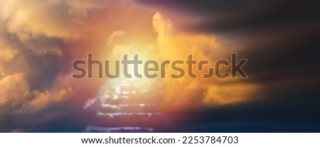 Religion,religious concept,banner background.Sunset with dramatic clouds,blurred stairs to heaven,sunlight from heaven,stairway leading up to skies clouds.Blurred soft focus.Copy space.