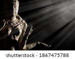 Religious artifact. Bronze statue of Hindu Goddess Lakshmi. Hinduism in close up. Museum quality exhibit against black background with copy space.