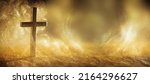 Religious cross in abstract wallpaper with shining gold sparkles and radiant lights. Symbolism of heaven or the resurrection.