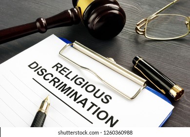 Religious Discrimination Claim And Pen On A Table.