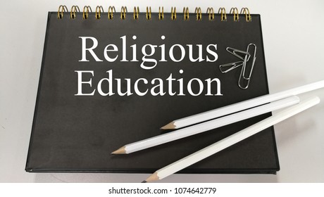 Religious Education Memo Written On A Notebook With Pencil And Paper Clip