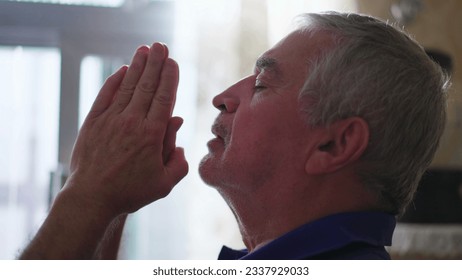 Religious Elderly man in PRAYER, devout Spiritual Older person having HOPE and FAITH