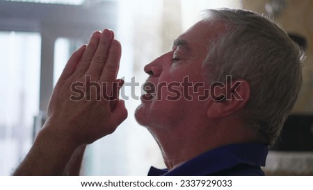 Religious Elderly man in PRAYER, devout Spiritual Older person having HOPE and FAITH