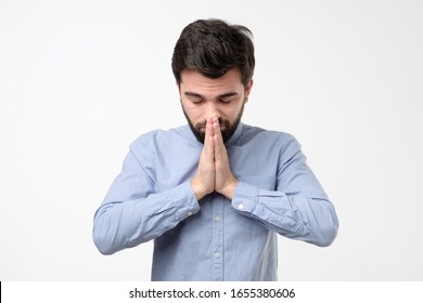 Religious Expressive Hispanic Man Praying In Studio On White Isolated Background