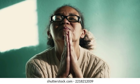 Religious Hispanic Older Woman Praying To God. South American Senior Lady In Prayer. Spiritual 60s Female Person In FAITH And HOPE. Contemplative Mature Lady