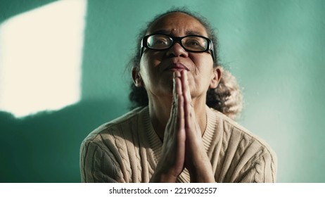 Religious Hispanic Older Woman Praying To God. South American Senior Lady In Prayer. Spiritual 60s Female Person In FAITH And HOPE. Contemplative Mature Lady