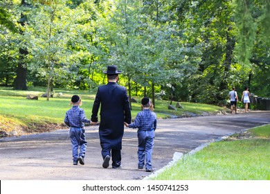 Religious Jew. A family of Hasidic Jews, a man with children, walks through the Autumn Park in Uman, Ukraine, Jewish New Year holiday