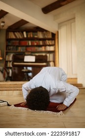 Religious Middle Eastern man praying at home.