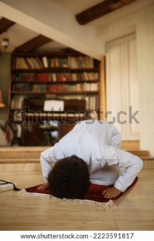 Religious Middle Eastern man praying at home.