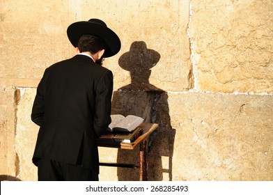 Religious orthodox jew praying at the Western wall in Jerusalem old city.