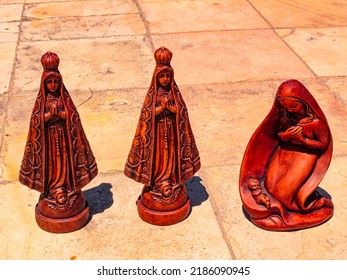 Religious Souvenirs Made Of Wood On A Stone Surface