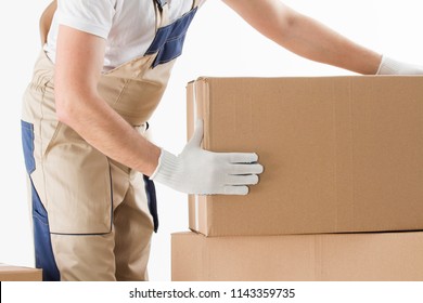 Relocation Services Concept. Mover In Uniform With Cardboardboxes Isolated On White Background.