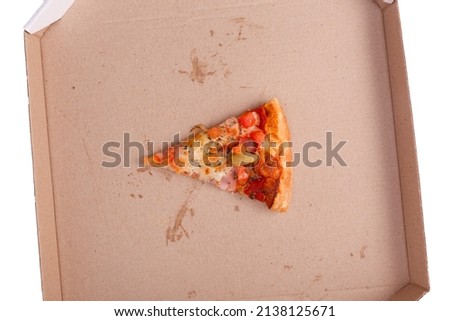The remaining pizza is in the box. Empty pizza box with one slice remains. Top view. Isolated on white.