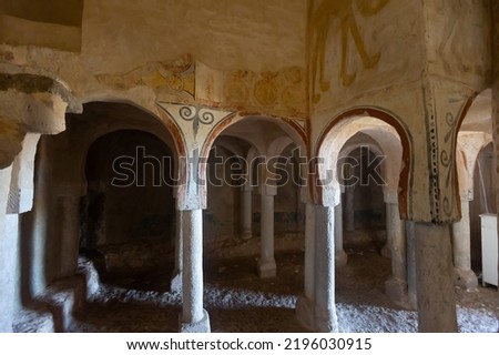 Remains of antique Romanesque frescoes on walls, ceiling and supporting pillar in ancient Church of San Baudelio de Berlanga in Spanish province of Soria