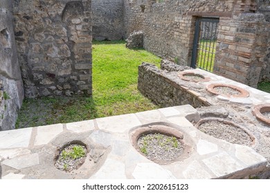 The Remains Of A Counter Where Food Was Sold At The Time Of The Devastating Volcano Eruption In Pompeii, Italy