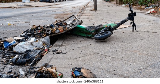 Remains of an e-scooter and rubbish on New Year's Day following vandalism and arson.