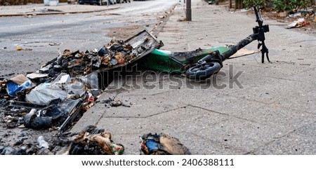 Remains of an e-scooter and rubbish on New Year's Day following vandalism and arson.