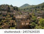 Remains of houses on a hill in the abandoned village of Kayaköy, Livissi, close to Fethiye, Turkey 2022