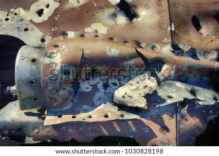 Remains of military aircraft (fighter) punched shell fragments and warmed by explosions of shells and bullets, splinter effect, fragment effect. Shoot down an aircraft, grand slam