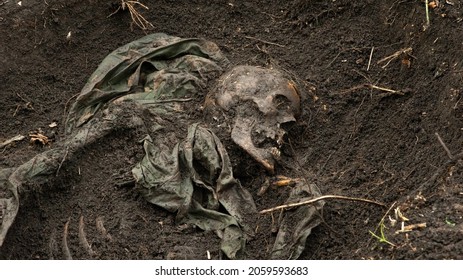 The remains of an unidentified man in camouflage clothing found by the police at the crime scene. - Shutterstock ID 2059593683