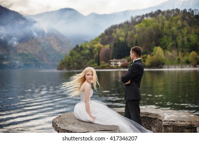 Remarkable glance of the blonde bride on the lakeside
