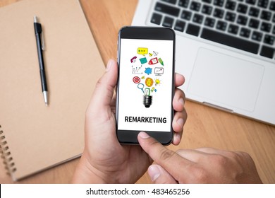 Remarketing Thoughtful male person looking to the digital phone screen,Silhouette top computer and hand - Powered by Shutterstock