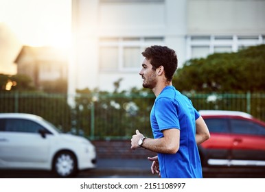 Remember To Always Push Forward. Shot Of A Sporty Young Man Out For A Run.