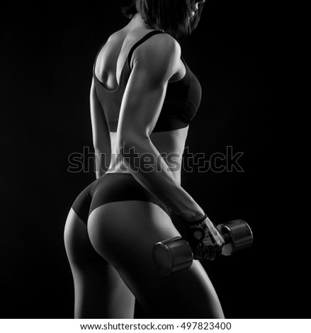 Remember why you started. Female bodybuilder working out lifting weights showing off her toned backside monochrome shot