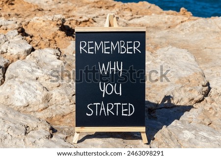 Remember why you started symbol. Concept word Remember why you started on beautiful black chalk blackboard. Beautiful stone blue sea background. Business remember why you started concept. Copy space.