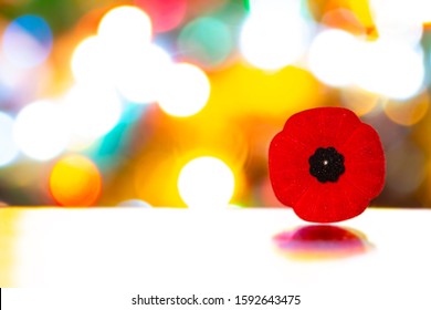 Remembrance Day Poppy Flower With Christmas Lights On A Table