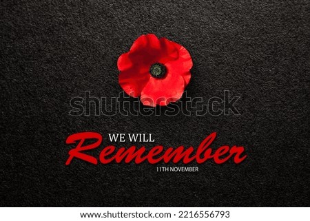The remembrance poppy - poppy appeal. Poppy flower on black textured background. Decorative flower for Remembrance Day.