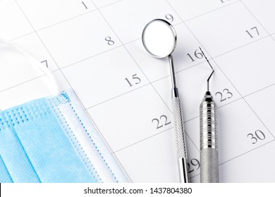 Reminder dentist appointment in calendar and professional dental tools.- Image - Shutterstock ID 1437804380