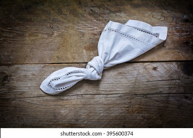 Reminder, Knot In Handkerchief Of White Cloth On A Rustic Wooden Background With Copy Space, Concept Of Recall And Dementia, View From Above