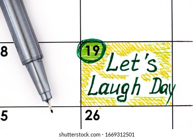 Reminder Let's Laugh Day In Calendar With Pen.  March 19. 