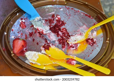 The Remnants Of A Delicious Dessert, Cake Are On The Serving Tray, Three Yellow Spoons And A Knife. The Crumbs From The Cake Remained On The Platter And The Knife And Spoons.