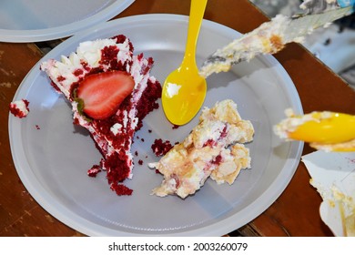 The Remnants Of A Delicious Dessert, Cake Are On The Serving Tray, Three Yellow Spoons And A Knife. The Crumbs From The Cake Remained On The Platter And The Knife And Spoons.