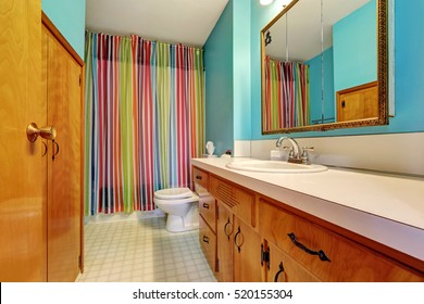 Remodeled Bathroom Interior With Colorful Shower Curtain And Blue Walls. Northwest, USA