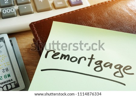 Remortgage concept. Memo stick, calculator and money.