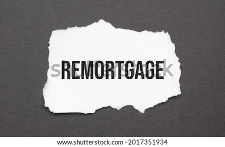 remortgage sign on the torn paper on the black background