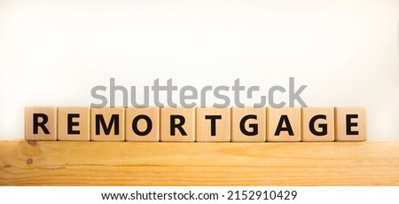 Remortgage symbol. The word 'Remortgage' written on wooden cubes. Business and remortgage concept. Copy space. Beautiful wooden table, white background.