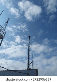 A remote base station towering on a rugged mountain peak under a vast sky. This solitary structure represents communication, technology, and human presence in remote natural landscapes.