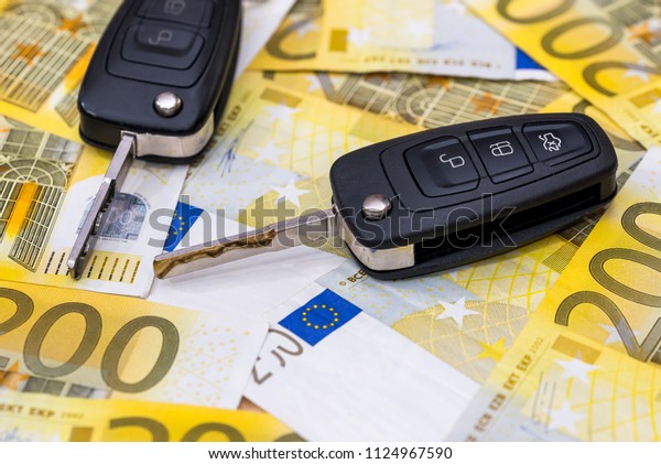 Remote car\
control on euro banknotes\
background