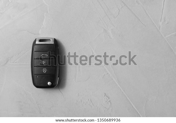 Remote car key on grey background, top view. Space
for text