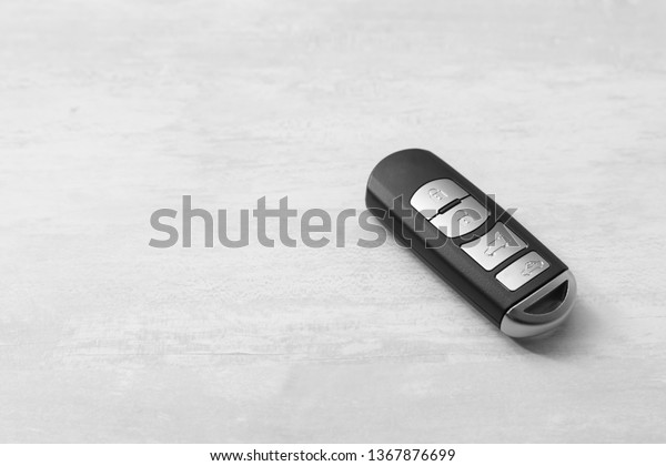 Remote car\
key on light background. Space for\
text