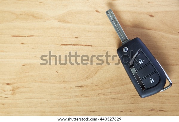 remote car key on wooden\
background