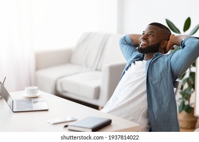 Remote Career. Cheerful African Freelancer Guy Leaning Back In Chair At Home - Powered by Shutterstock