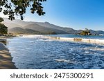 Remote Castelhanos beach on Ilhabela island with mountains and forest around