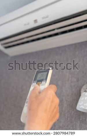 Remote control adjusting wall-mounted split air conditioner for efficient home cooling