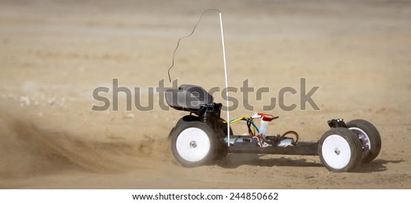 Remote control car running on\
sand